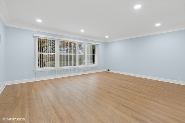 unfurnished room featuring crown molding and light hardwood / wood-style floors