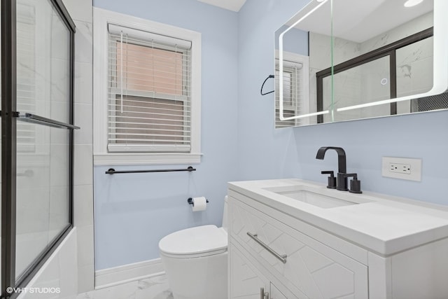 full bathroom featuring shower / bath combination with glass door, vanity, and toilet