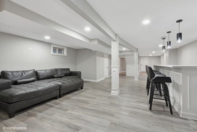 living room featuring bar area and light hardwood / wood-style flooring