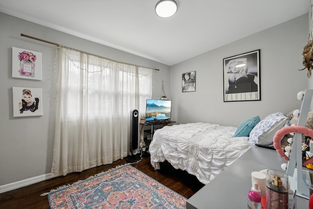 bedroom featuring lofted ceiling and dark wood-type flooring