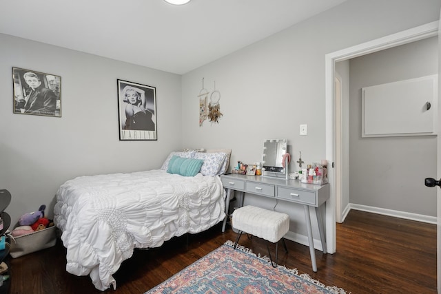 bedroom with dark hardwood / wood-style floors