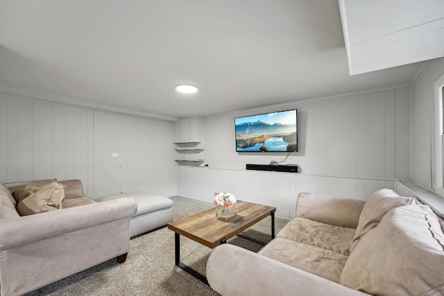 carpeted living room featuring wood walls