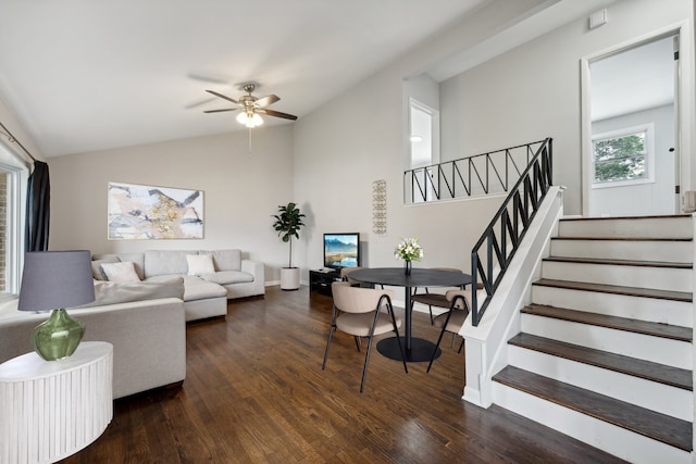 living room featuring ceiling fan, dark hardwood / wood-style flooring, and vaulted ceiling