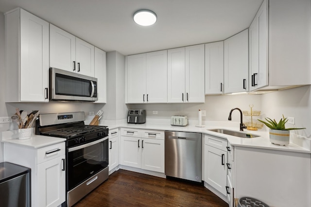 kitchen featuring white cabinets, dark hardwood / wood-style floors, sink, and stainless steel appliances