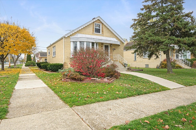 bungalow-style house featuring a front yard