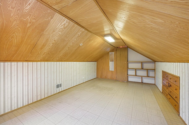 additional living space featuring lofted ceiling