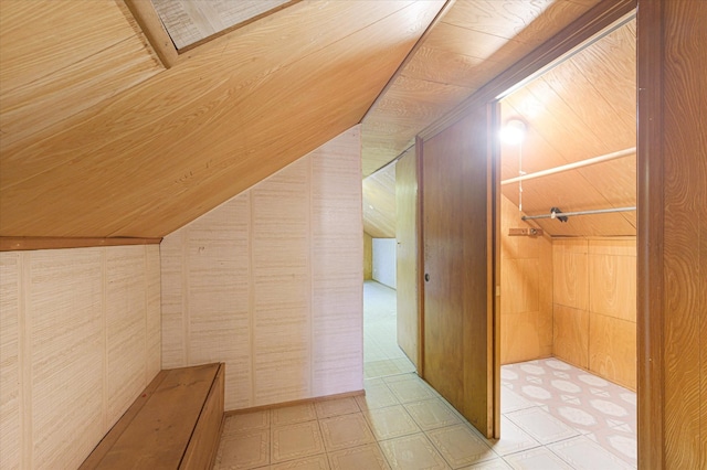 bonus room featuring wooden walls and lofted ceiling