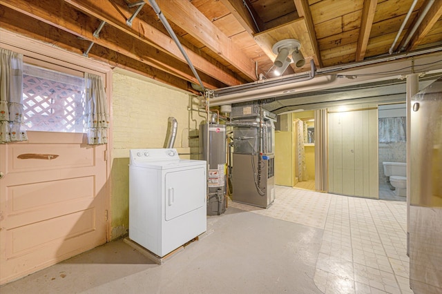 basement featuring washer / dryer, heating unit, and water heater