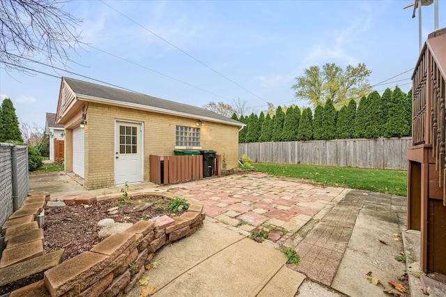 view of patio with an outbuilding and a garage