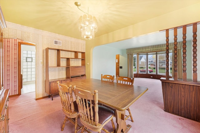 dining area featuring carpet floors and a chandelier