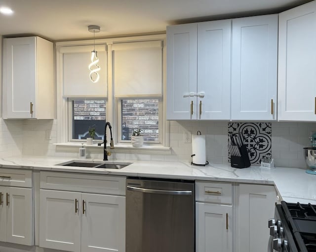 kitchen with sink, white cabinetry, stainless steel appliances, and hanging light fixtures