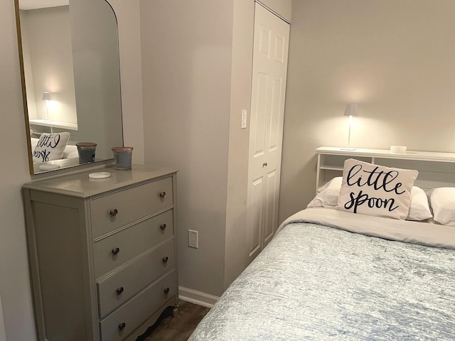 bedroom featuring dark hardwood / wood-style flooring and a closet