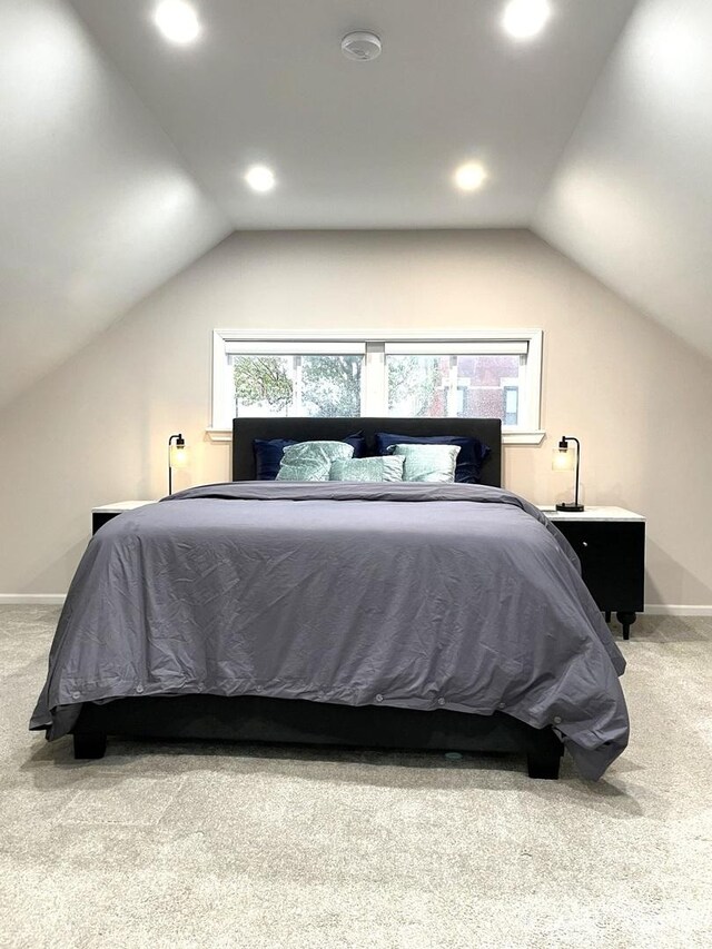 bedroom featuring carpet flooring and lofted ceiling