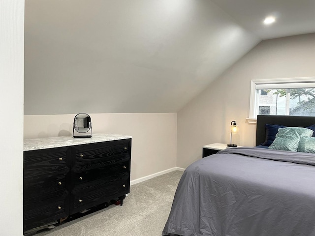 carpeted bedroom with lofted ceiling