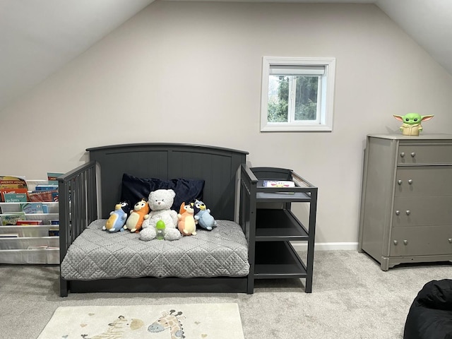 bedroom featuring light colored carpet and vaulted ceiling