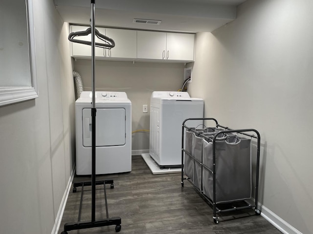 laundry room with cabinets, independent washer and dryer, and dark hardwood / wood-style flooring