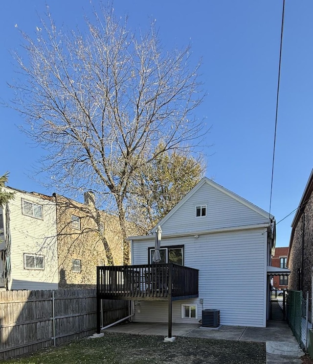 back of property with a patio area, central air condition unit, and a wooden deck