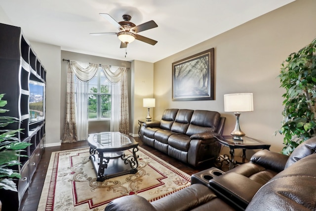 living room featuring ceiling fan and dark hardwood / wood-style flooring