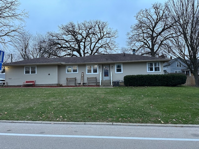 view of front of home with a front lawn and cooling unit