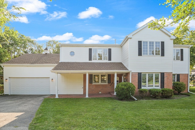 front of property with a garage and a front lawn