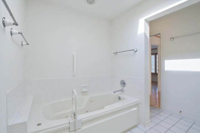 bathroom with tile patterned flooring and a bathtub