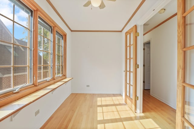 spare room featuring french doors, light hardwood / wood-style floors, ceiling fan, and crown molding