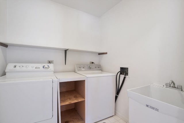 washroom featuring washing machine and clothes dryer and sink