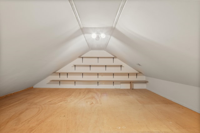 additional living space featuring lofted ceiling