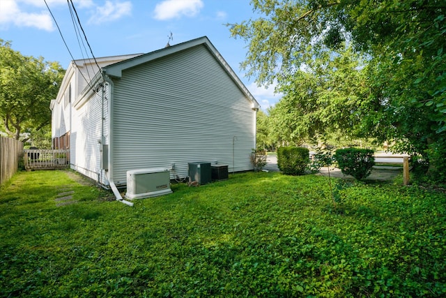 view of side of home with a lawn