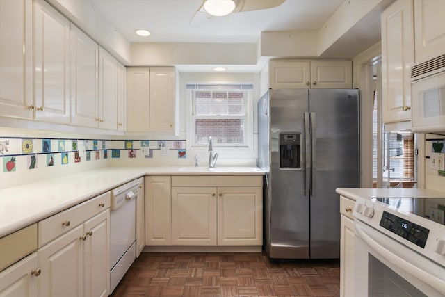 kitchen featuring dark parquet flooring, decorative backsplash, sink, and white appliances