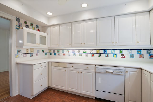 kitchen featuring tasteful backsplash, white cabinetry, dishwasher, and dark parquet floors