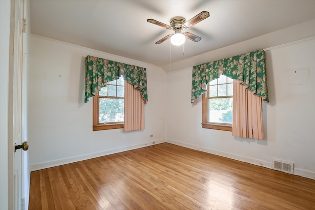 unfurnished room featuring ceiling fan, hardwood / wood-style floors, and a healthy amount of sunlight