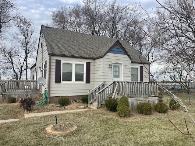 bungalow featuring a deck and a front yard