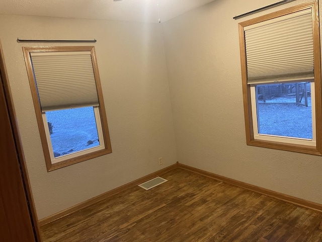 spare room with hardwood / wood-style floors