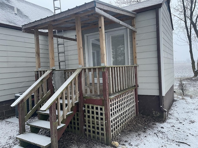 view of snow covered property entrance