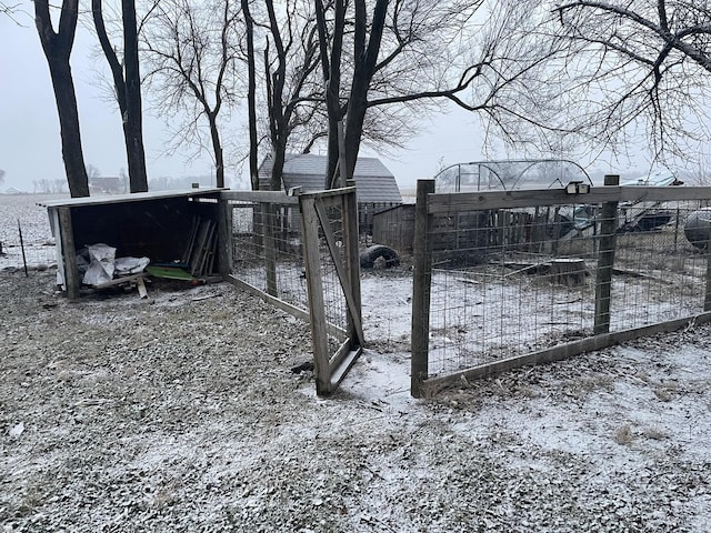 snowy yard with an outdoor structure