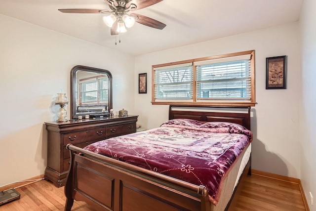 bedroom featuring light hardwood / wood-style flooring, multiple windows, and ceiling fan