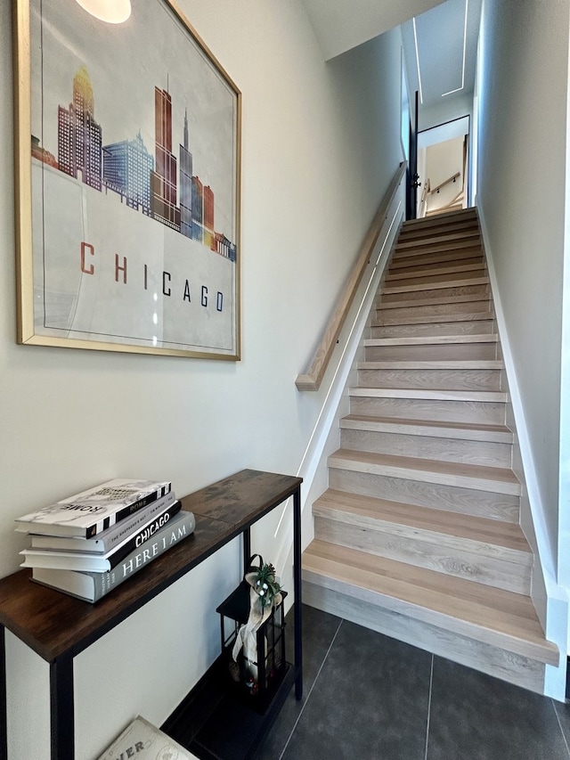 stairway with tile patterned floors