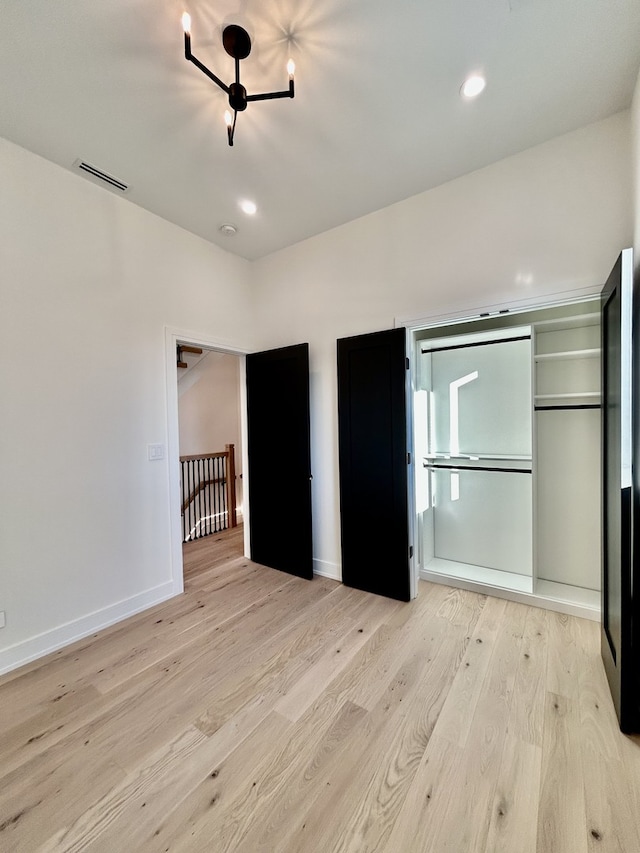 unfurnished bedroom featuring light wood-type flooring