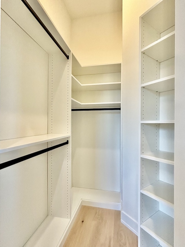 spacious closet featuring light hardwood / wood-style floors