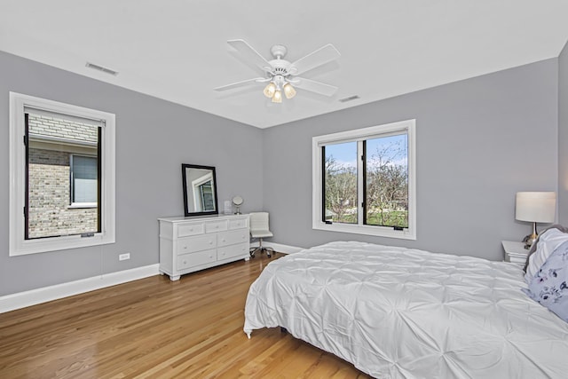 bedroom with ceiling fan and light wood-type flooring