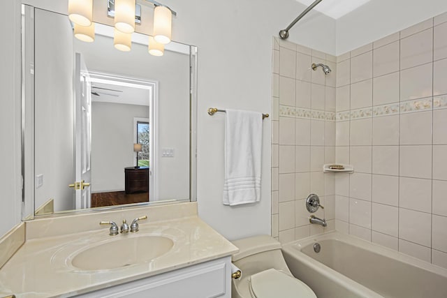 full bathroom with vanity, toilet, and tiled shower / bath combo