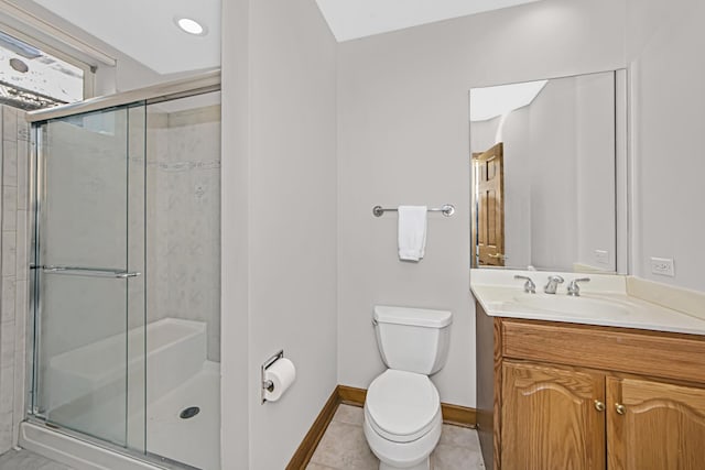 bathroom featuring vanity, a shower with shower door, tile patterned floors, and toilet