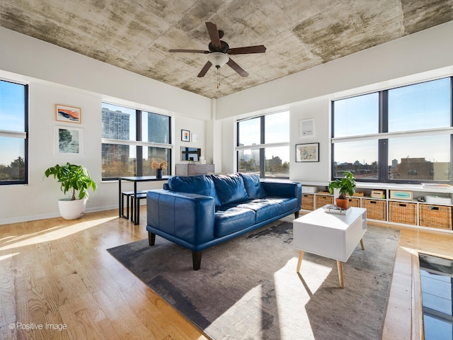 living room featuring ceiling fan and light hardwood / wood-style floors