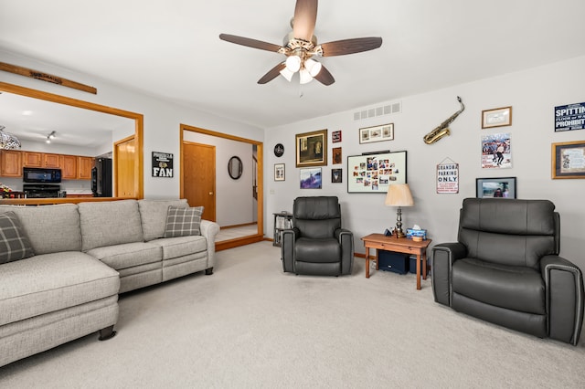 living room with light carpet and ceiling fan