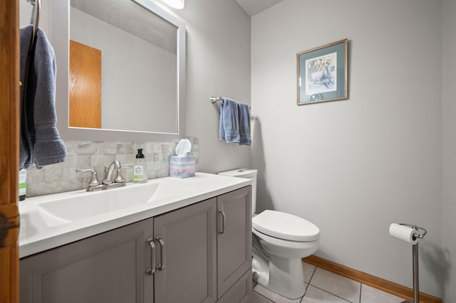 bathroom with vanity, backsplash, tile patterned floors, and toilet