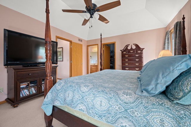 bedroom featuring carpet floors, ensuite bath, vaulted ceiling, and ceiling fan