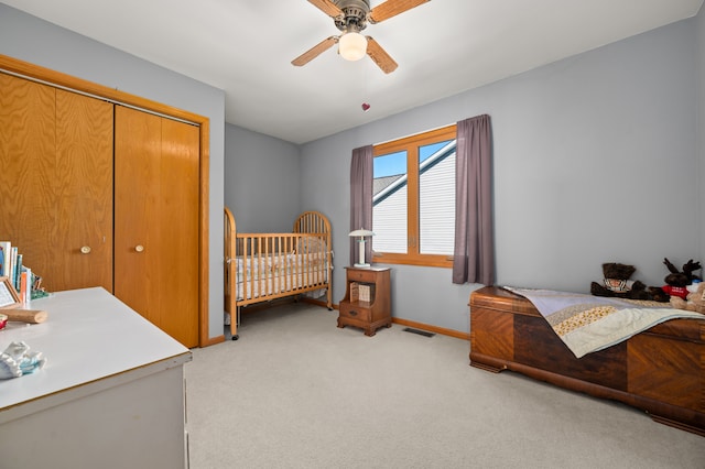 bedroom featuring light carpet, a closet, and ceiling fan