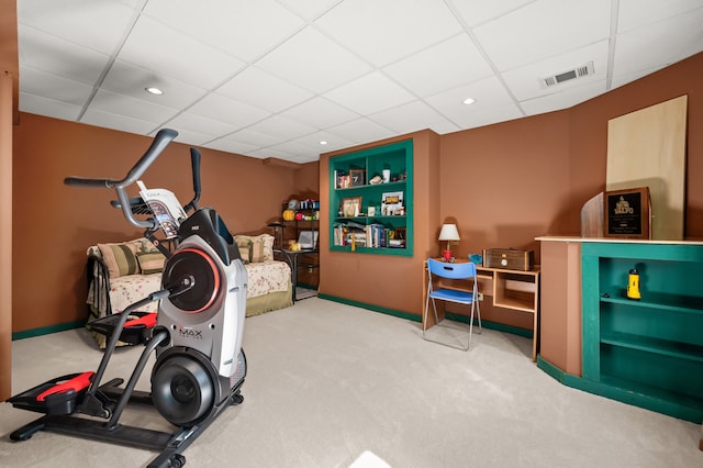 exercise room with carpet flooring and a drop ceiling