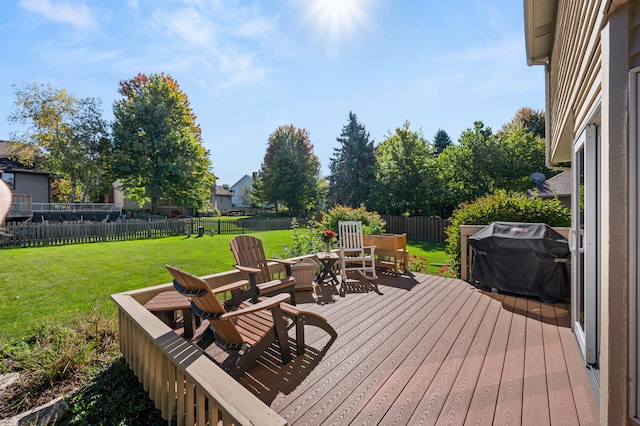 deck featuring a yard and a grill